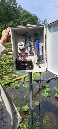 Hand opening an outdoor electrical box